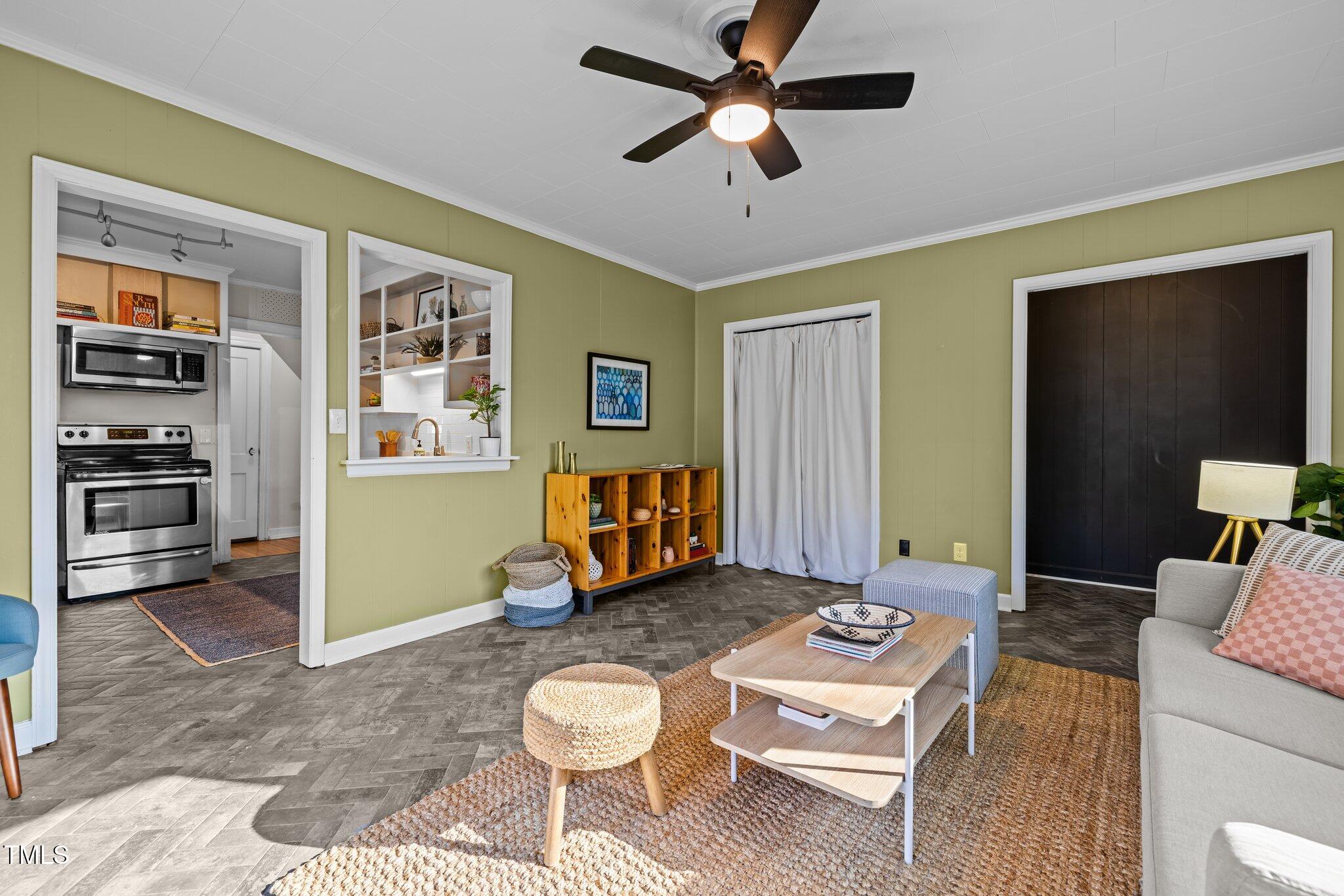 2511 State Street Durham, NC 27704 - Photo 18 of 45 a living room with furniture a rug and a ceiling fan