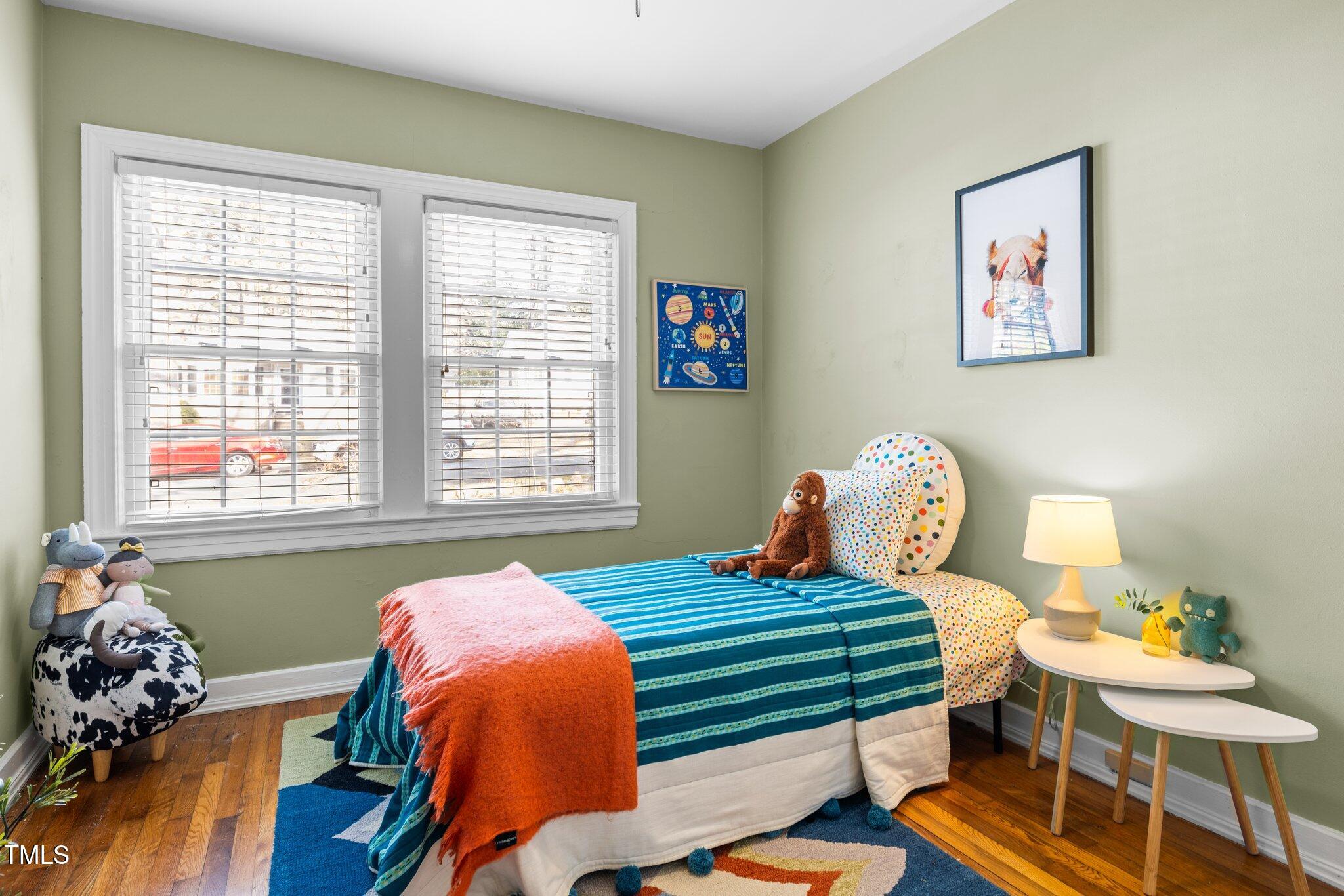 2511 State Street Durham, NC 27704 - Photo 23 of 45 a bedroom with a bed and wooden floor