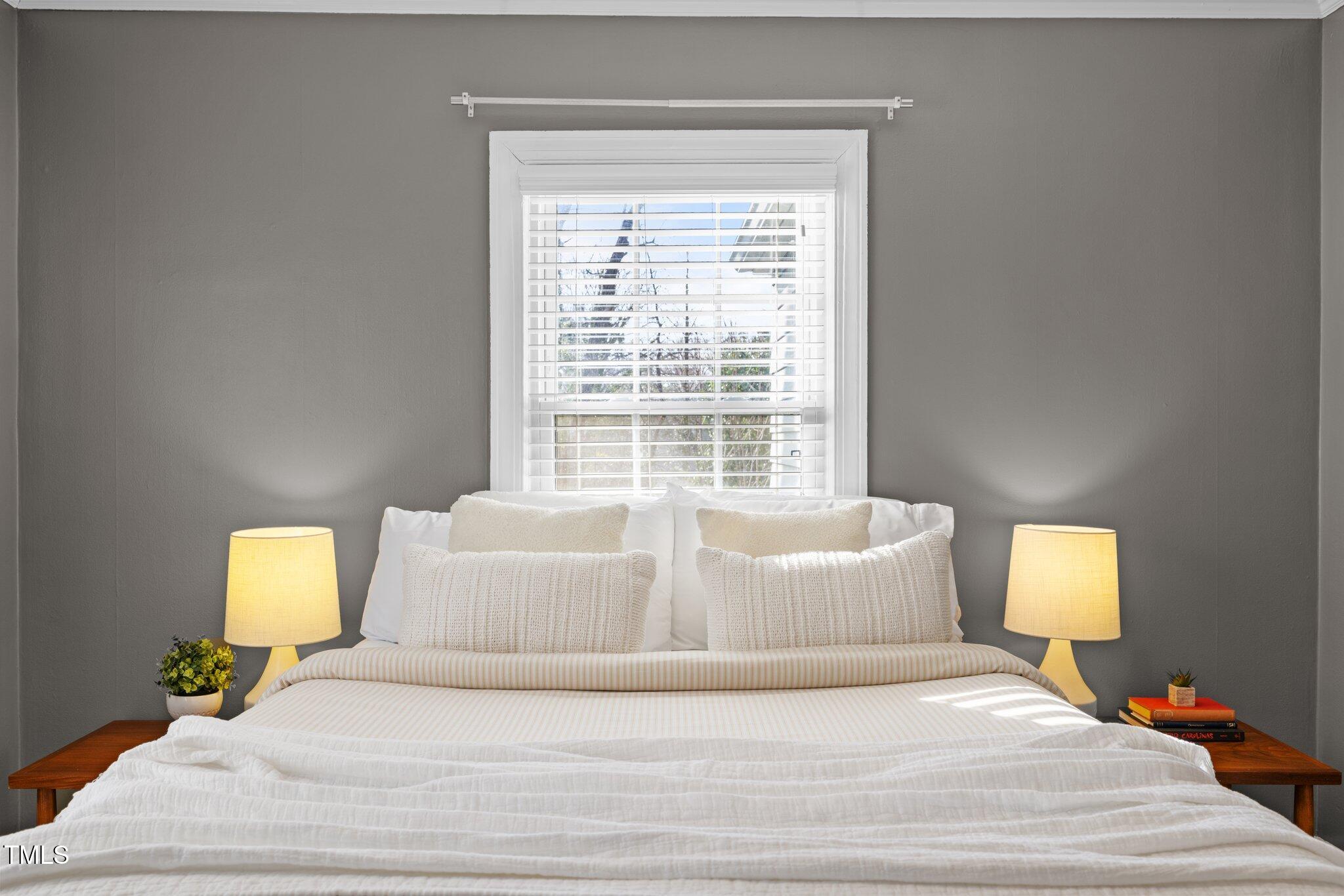 2511 State Street Durham, NC 27704 - Photo 25 of 45 a spacious bedroom with a bed and a couch