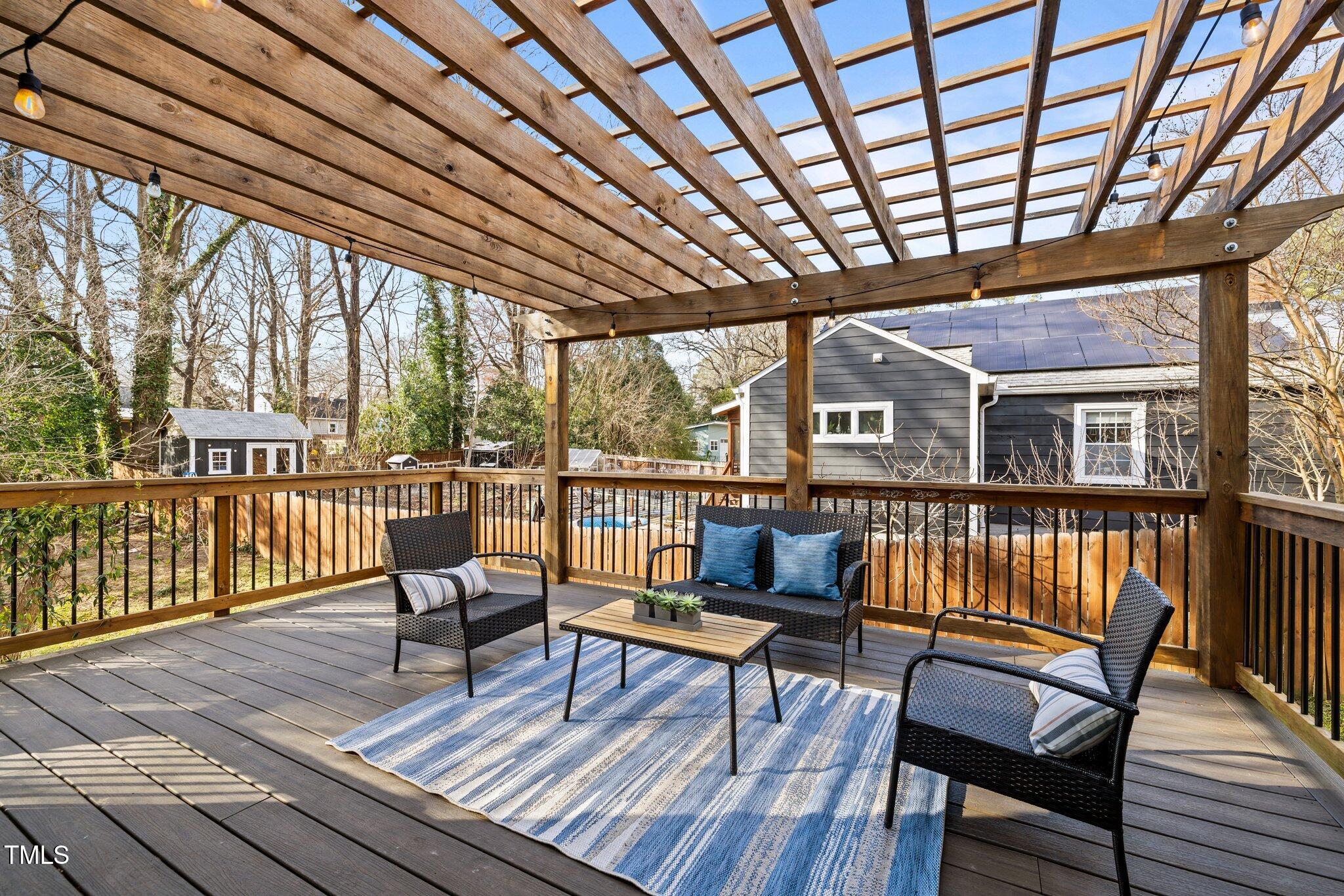 2511 State Street Durham, NC 27704 - Photo 29 of 45 a roof deck with wooden floor and outdoor seating