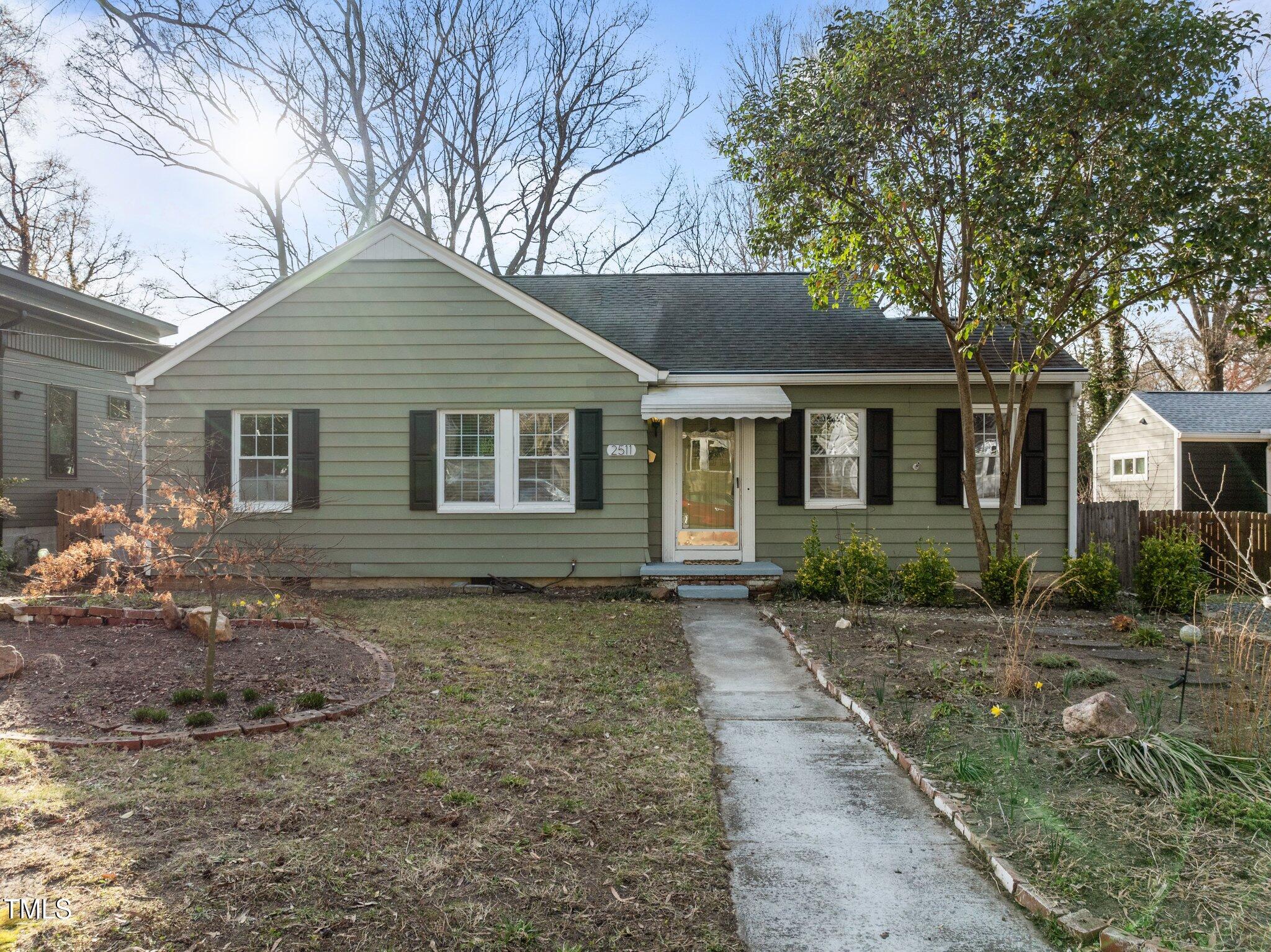 2511 State Street Durham, NC 27704 - Photo 2 of 45 a front view of a house with a garden
