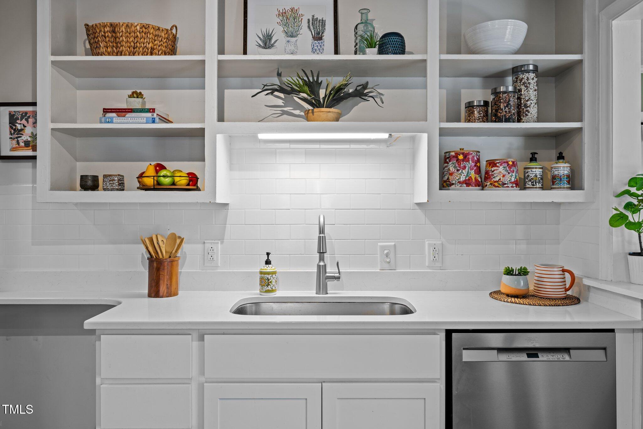 2511 State Street Durham, NC 27704 - Photo 8 of 45 a kitchen with a sink a lots of different kinds of fruit on it