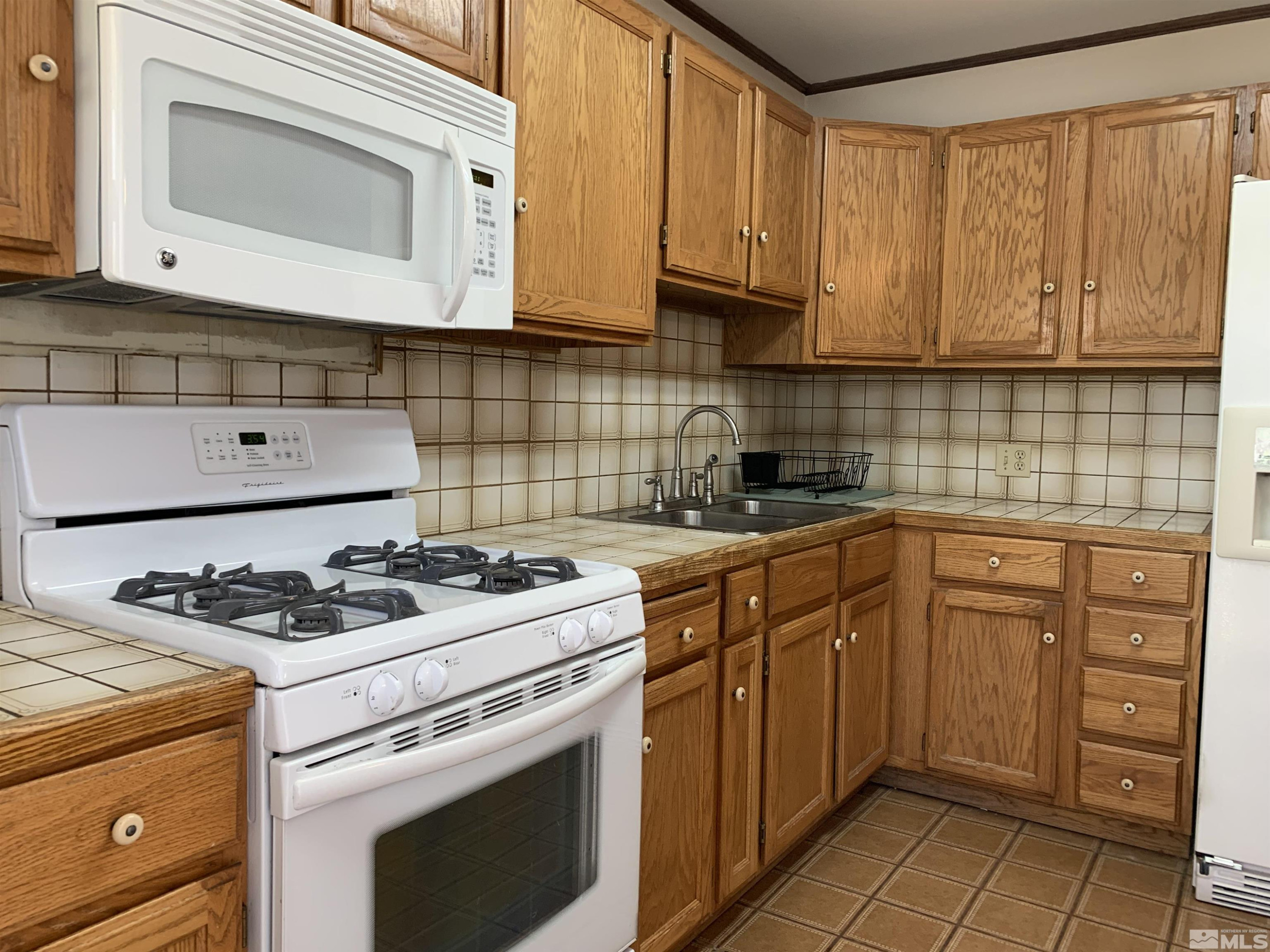 895 Lodge Avenue Reno, NV 89503 - Photo 3 of 28 a kitchen with cabinets appliances and a sink