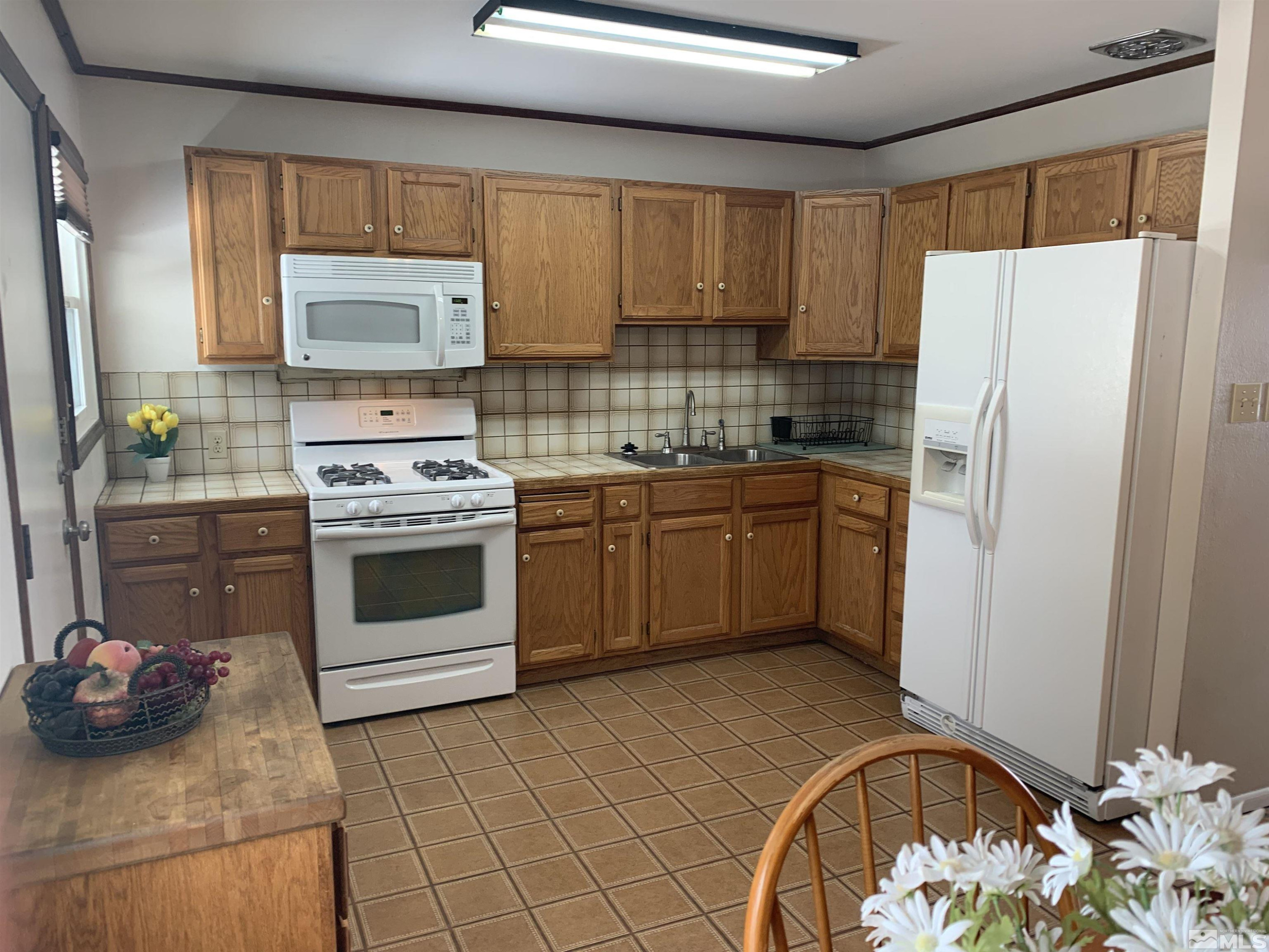 895 Lodge Avenue Reno, NV 89503 - Photo 5 of 28 a kitchen with a stove a sink and a refrigerator