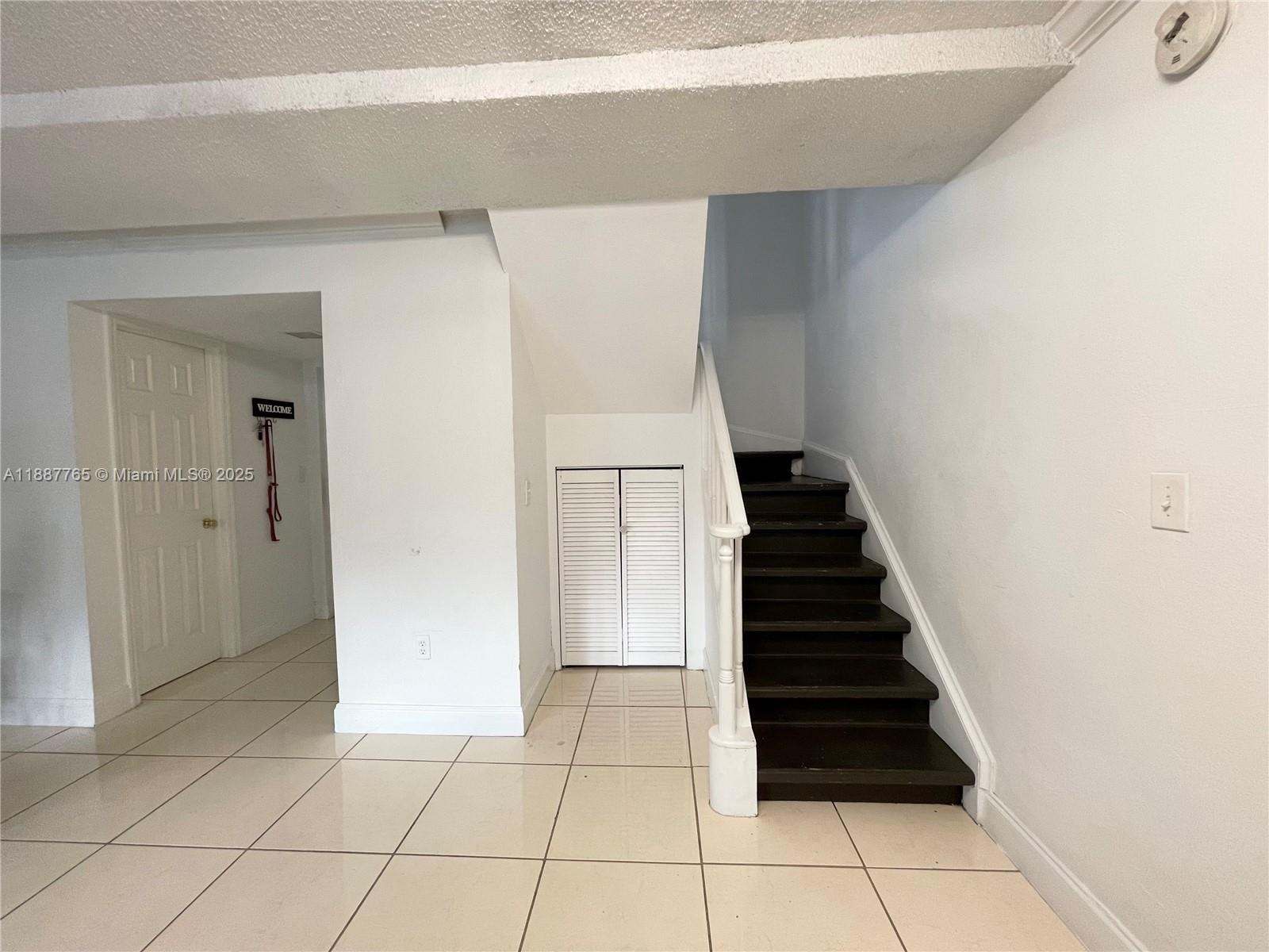 9301 Southwest 4th Street, Unit 224C Miami, FL 33174 - Photo 13 of 19 a view of a hallway with stairs and a door