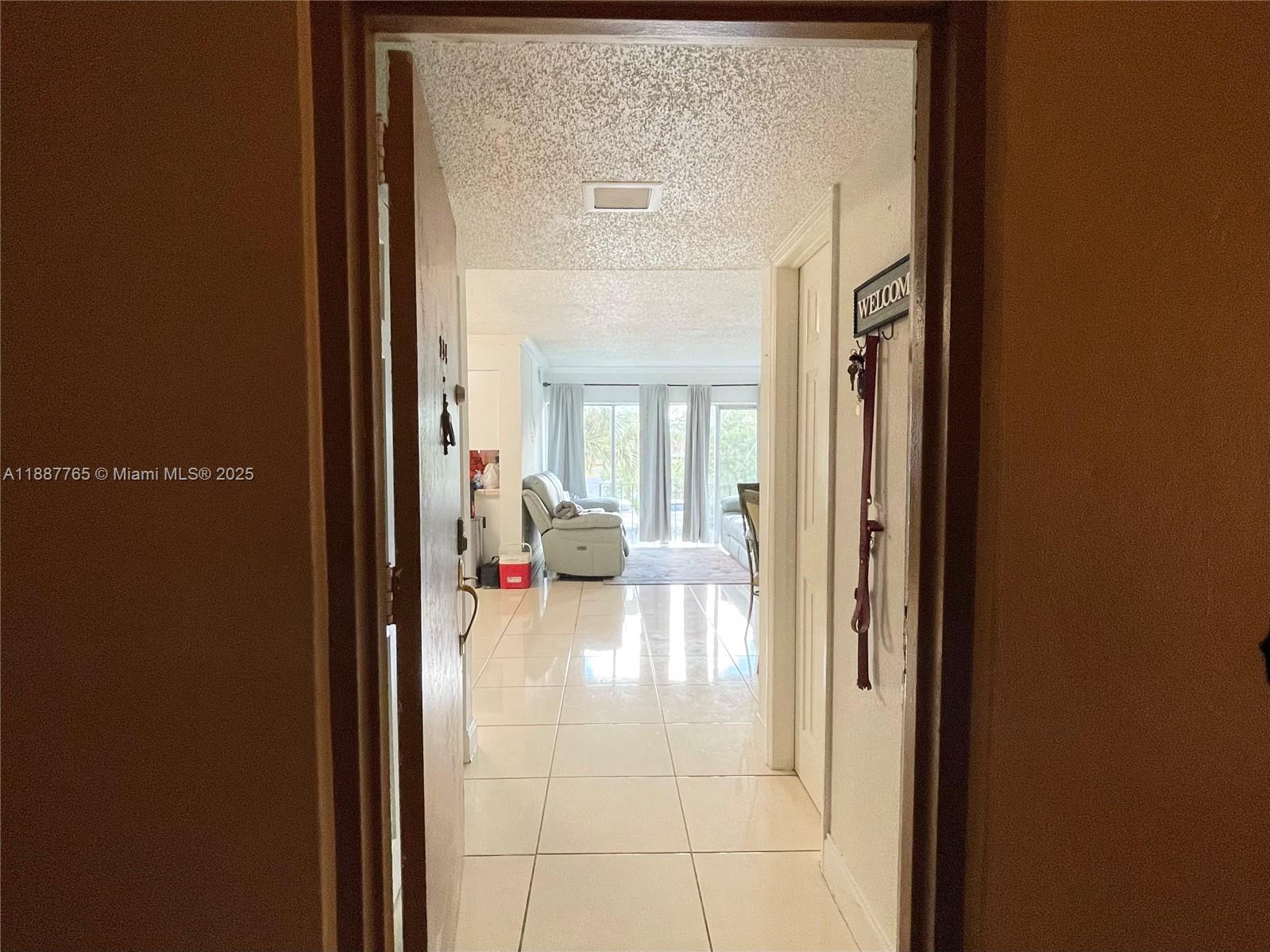 9301 Southwest 4th Street, Unit 224C Miami, FL 33174 - Photo 14 of 19 a view of a livingroom with furniture and front door