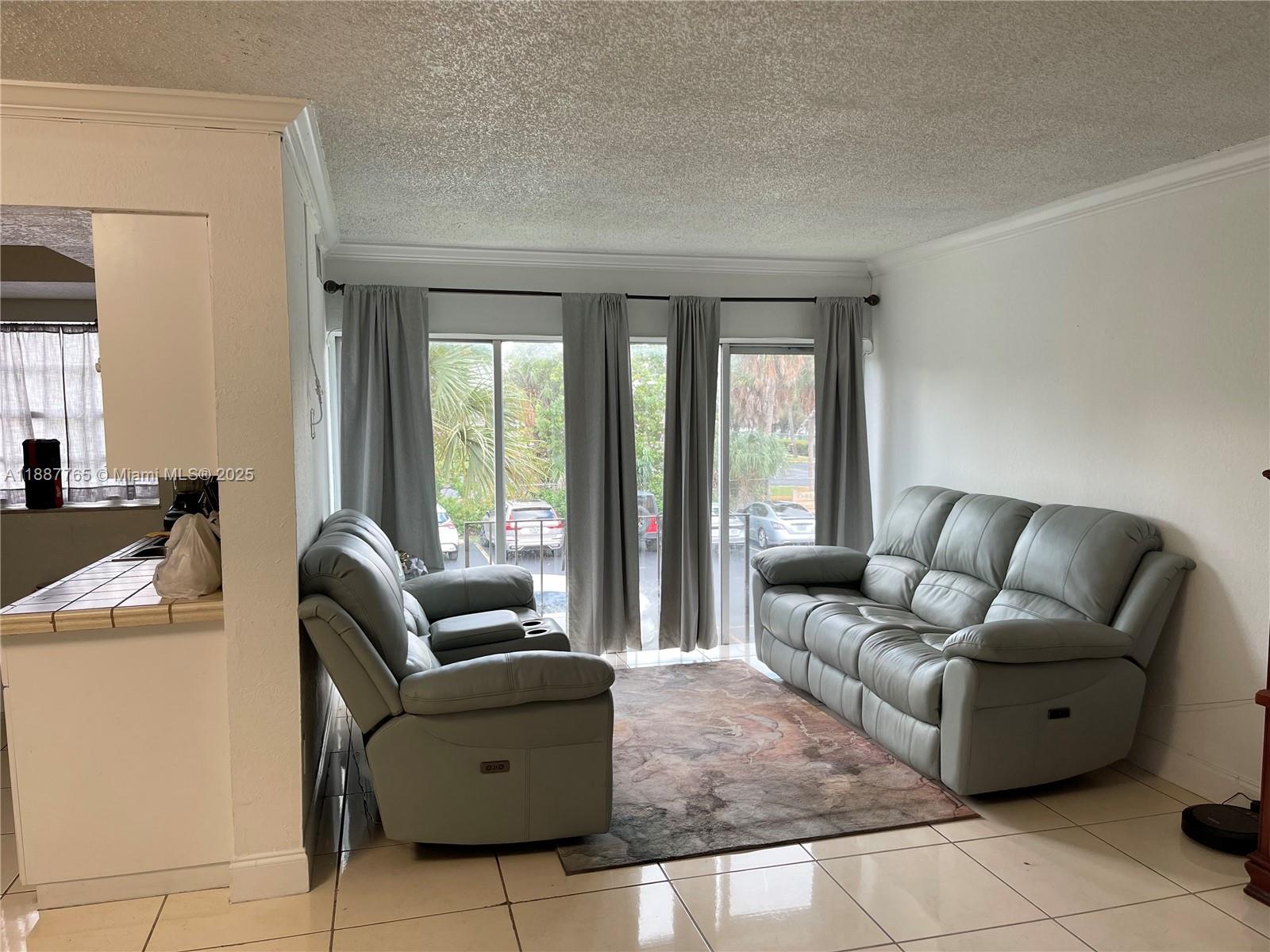 9301 Southwest 4th Street, Unit 224C Miami, FL 33174 - Photo 2 of 19 a living room with furniture and floor to ceiling window
