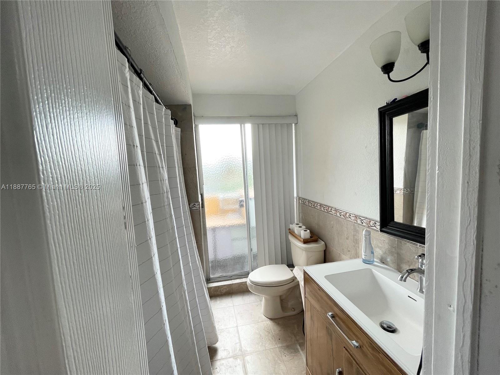 9301 Southwest 4th Street, Unit 224C Miami, FL 33174 - Photo 7 of 19 a bathroom with a bathtub sink toilet and mirror