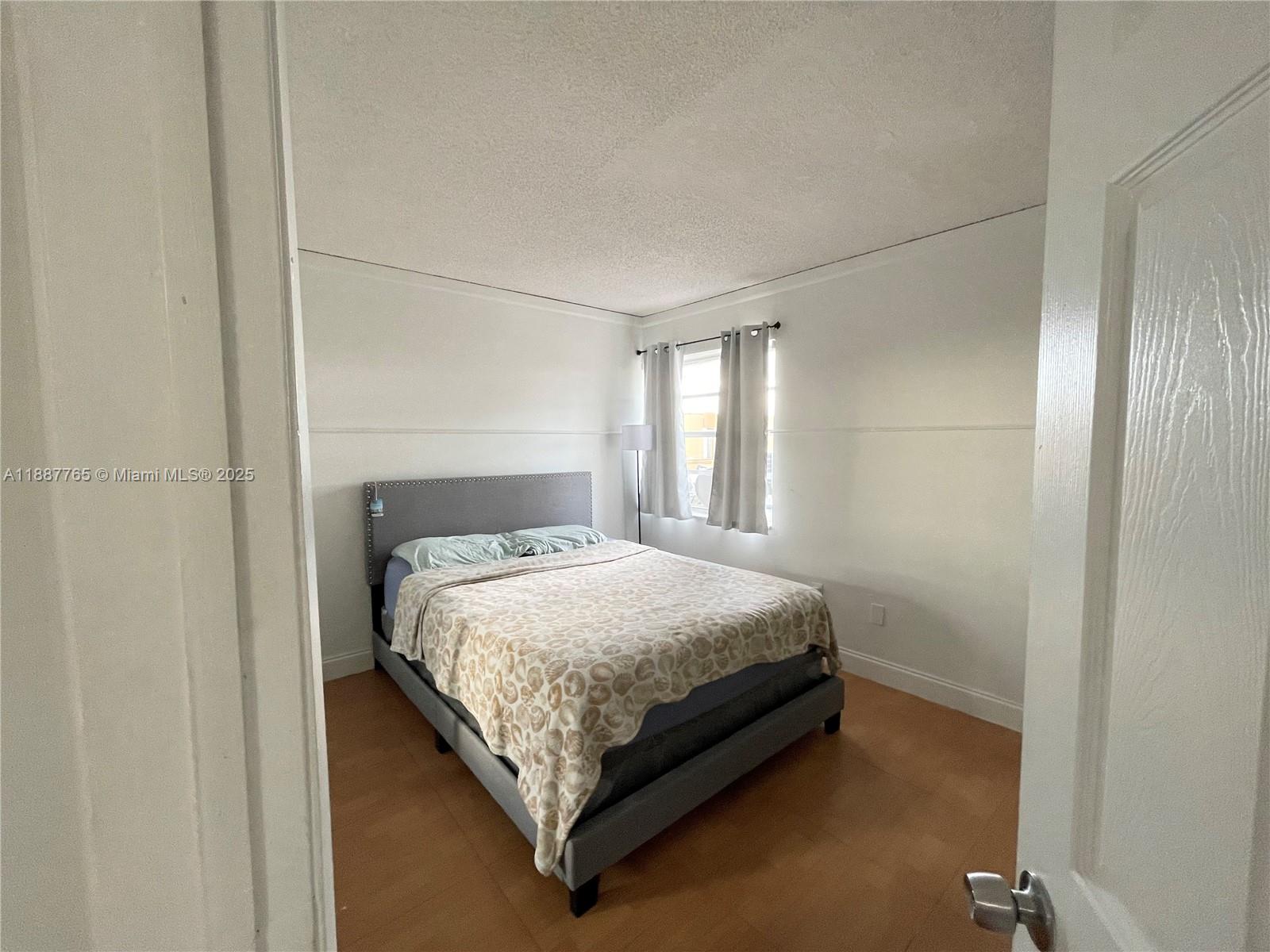 9301 Southwest 4th Street, Unit 224C Miami, FL 33174 - Photo 10 of 19 a bedroom with a bed and window