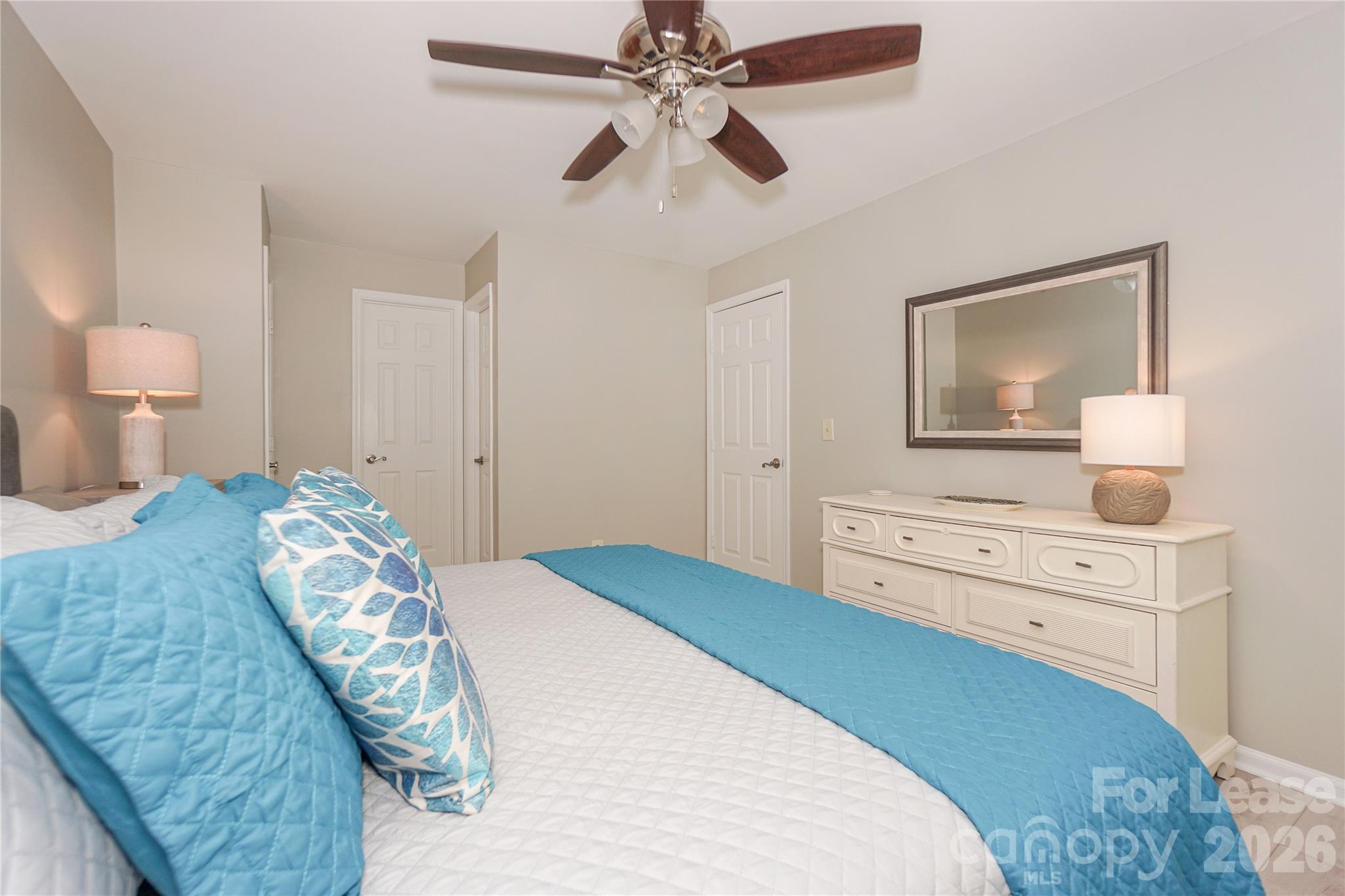 20105 Henderson Road, Unit E Cornelius, NC 28031 - Photo 27 of 31 a bedroom with a bed and a chandelier