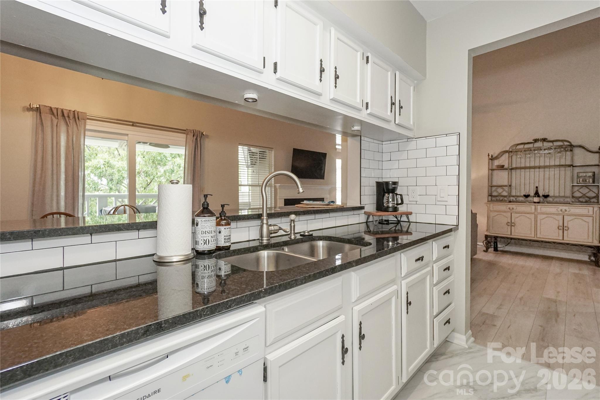 20105 Henderson Road, Unit E Cornelius, NC 28031 - Photo 8 of 31 a kitchen with stainless steel appliances granite countertop a sink and a stove