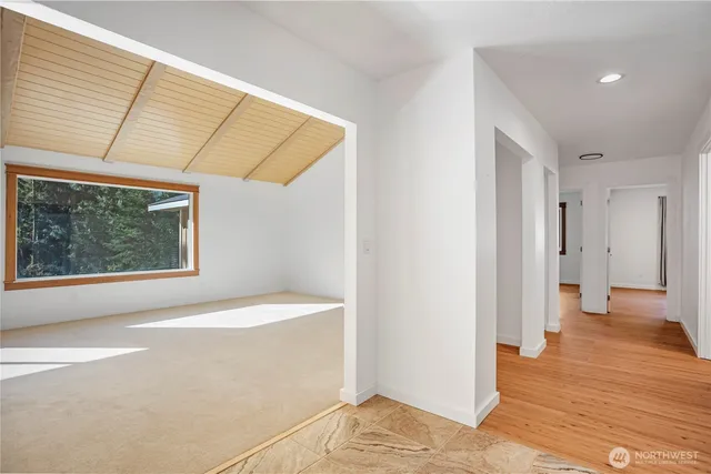 a view of a room with wooden floor and a window