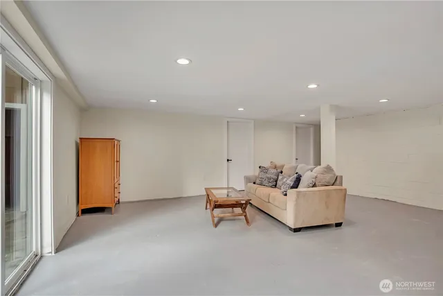 a living room with furniture and a wall painting