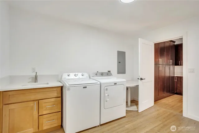 a view of washer and dryer with wooden floor