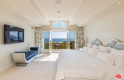 a bathroom with a granite countertop sink and a bathtub