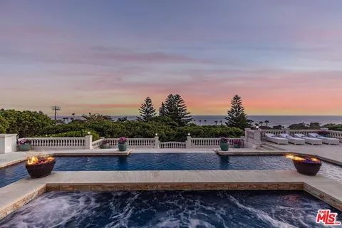 a living room with furniture and chandelier