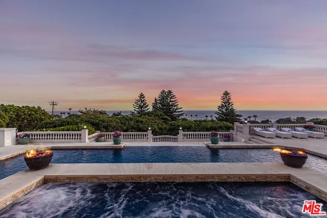 a living room with furniture and chandelier