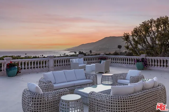 an aerial view of a house with swimming pool outdoor seating and yard