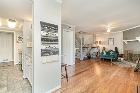 a living room with furniture and a wooden floor
