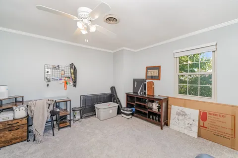 a view of a workspace with furniture and a window