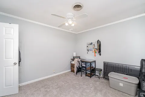 a view of a livingroom with furniture and a ceiling fan