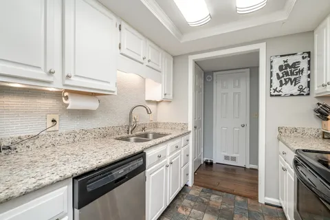 a kitchen with a sink stove and cabinets