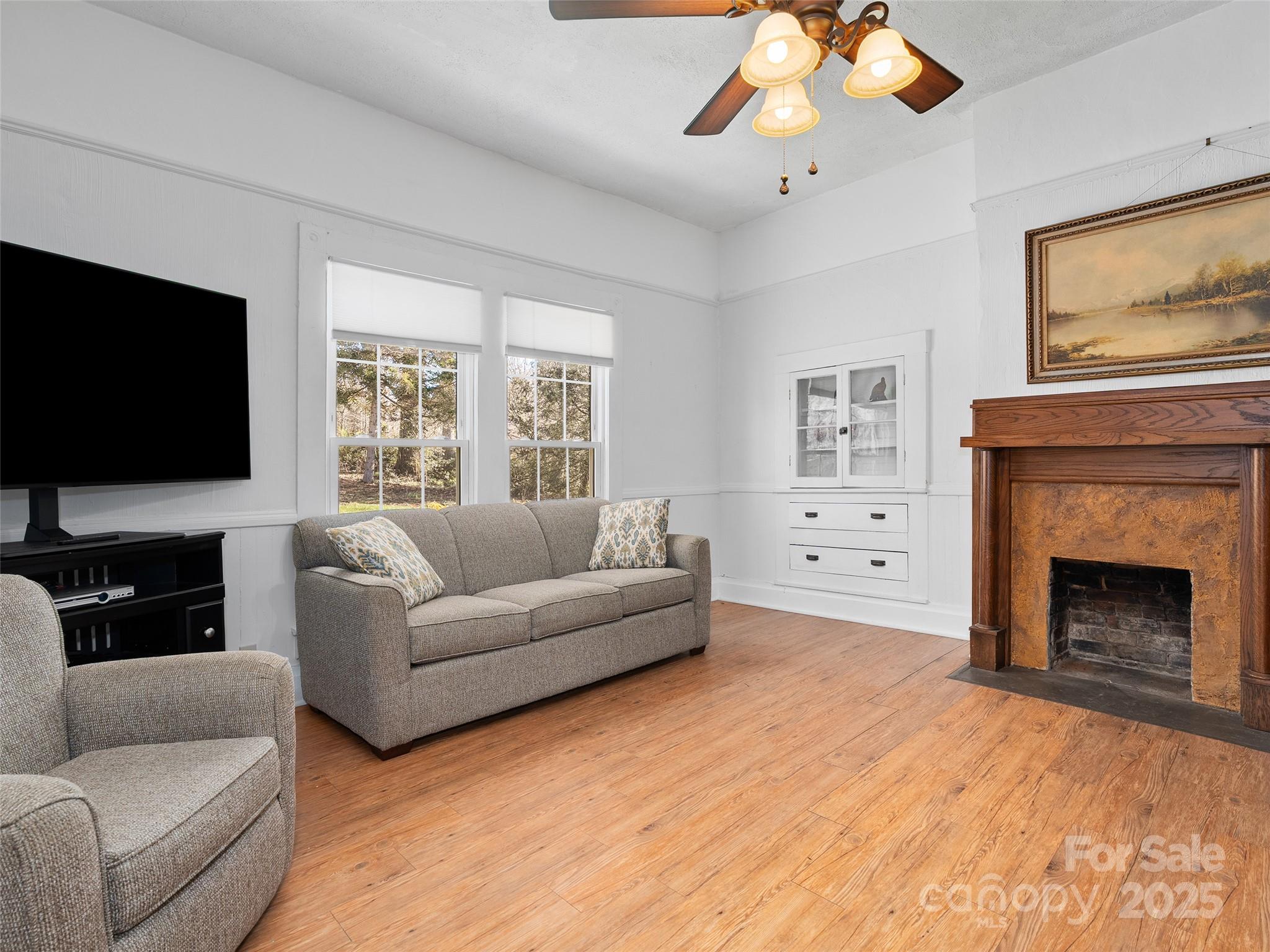4739 Old Clyde Road Clyde, NC 28721 - Photo 12 of 35 a living room with furniture a flat screen tv and a fireplace
