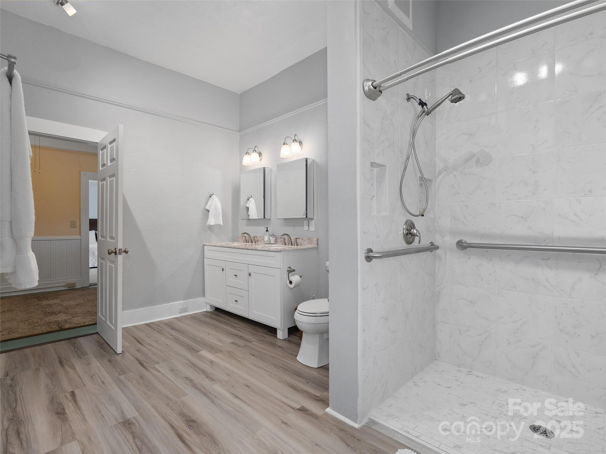 4739 Old Clyde Road Clyde, NC 28721 - Photo 16 of 35 a bathroom with a sink a toilet and shower