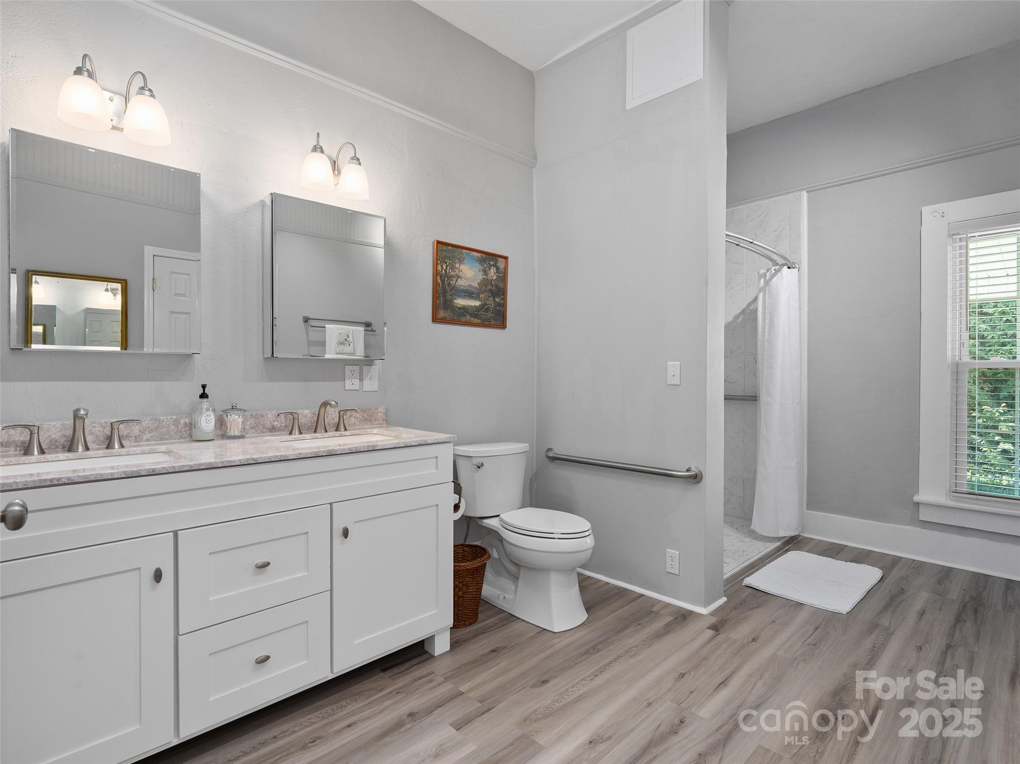 4739 Old Clyde Road Clyde, NC 28721 - Photo 17 of 35 a bathroom with a toilet sink double vanity and mirror