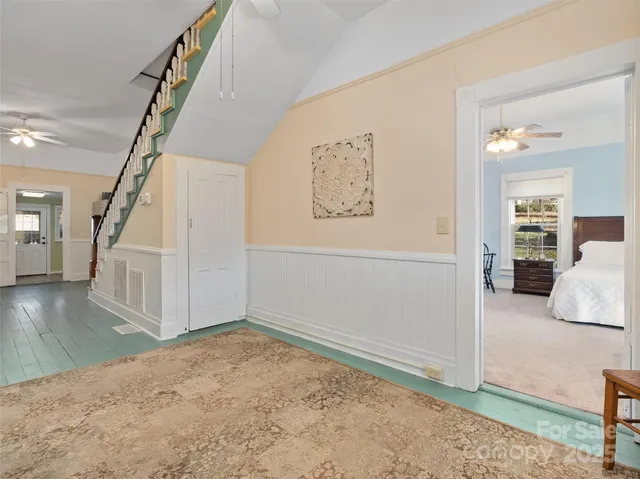 a view of entryway and hall with wooden floor