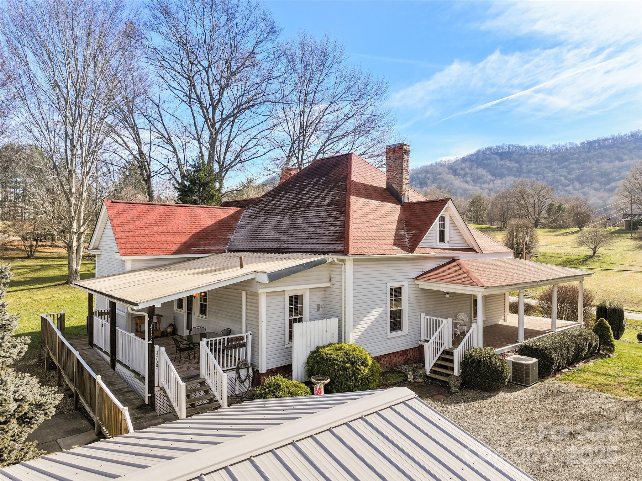4739 Old Clyde Road Clyde, NC 28721 - Photo 4 of 35 a front view of a house with garden