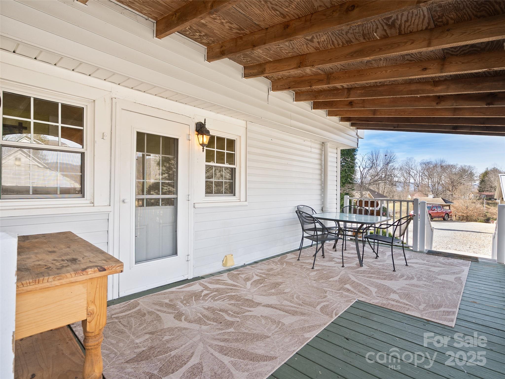 4739 Old Clyde Road Clyde, NC 28721 - Photo 6 of 35 a dining room with furniture and a floor to ceiling window
