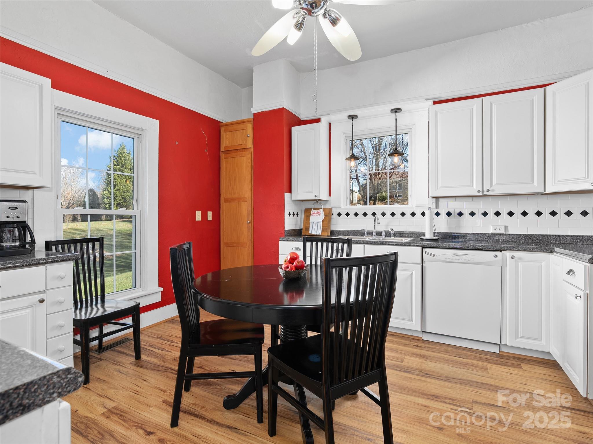 4739 Old Clyde Road Clyde, NC 28721 - Photo 9 of 35 a view of a dining room with furniture window and wooden floor