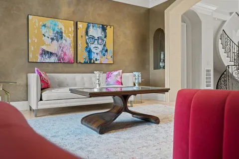 a living room with furniture fireplace and flat screen tv