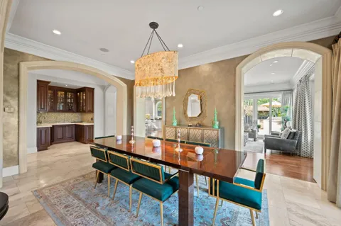 a large living room with stainless steel appliances granite countertop a couch and a wooden floors