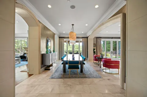 a large kitchen with granite countertop a large window and white cabinets