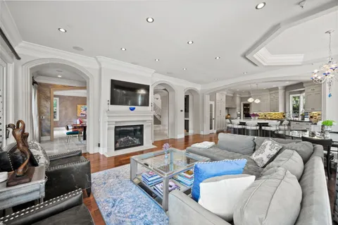 a large kitchen with granite countertop a large window and white cabinets