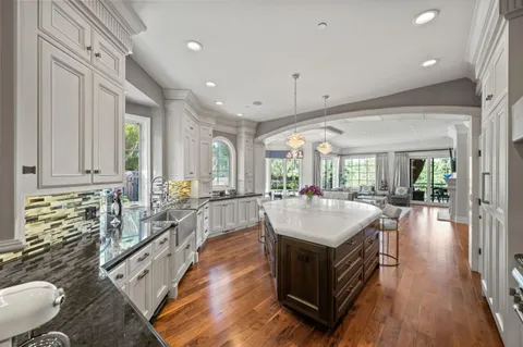 a bedroom with a large bed and a chandelier