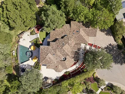 a view of a house with swimming pool and sitting area