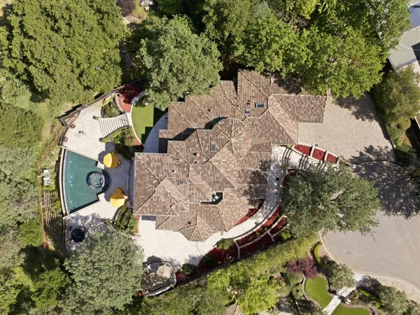 a view of a house with swimming pool and sitting area