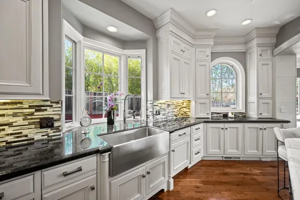 a bathroom with a granite countertop shower and a sink