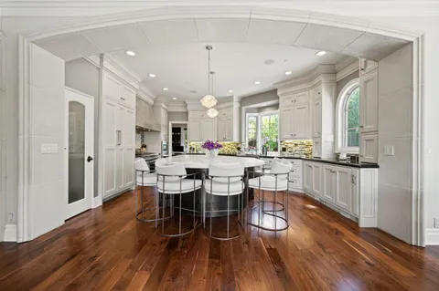 a living room with furniture and large windows