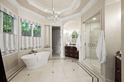 a bathroom with a granite countertop shower and a sink