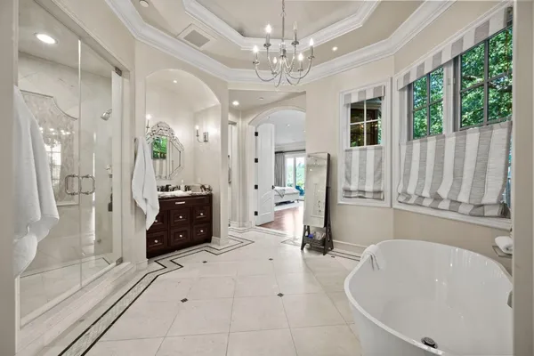 a living room with furniture and a large mirror with wooden floor