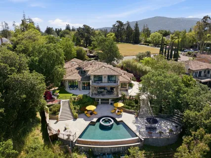 a view of a house with a yard and sitting area