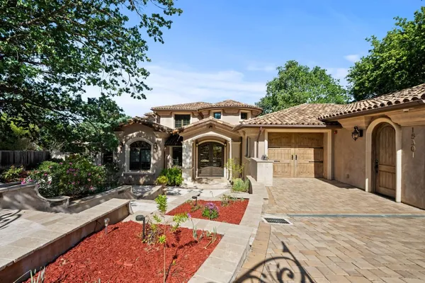 a view of a backyard with swimming pool and sitting area