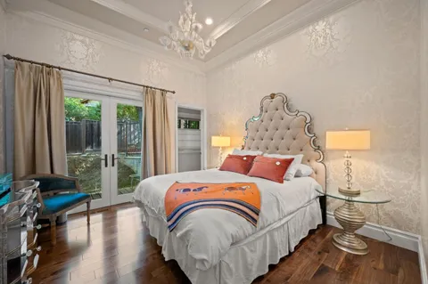 a living room with furniture and a large mirror with wooden floor