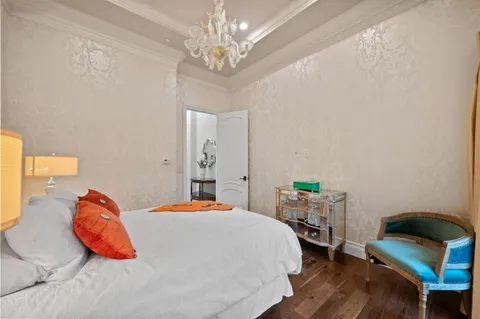 a bedroom with furniture and wooden floor