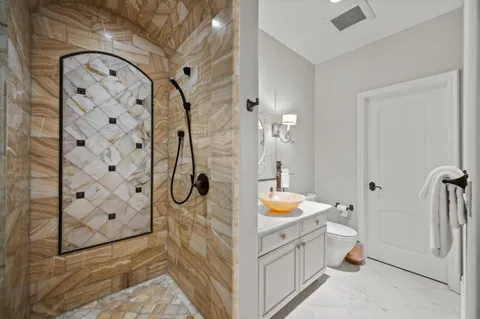 a view of a backyard with table and chairs potted plants and wooden fence