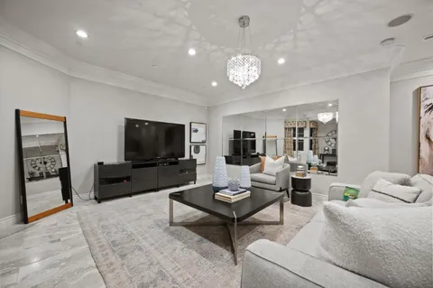 a view of a livingroom with a couch and chandelier